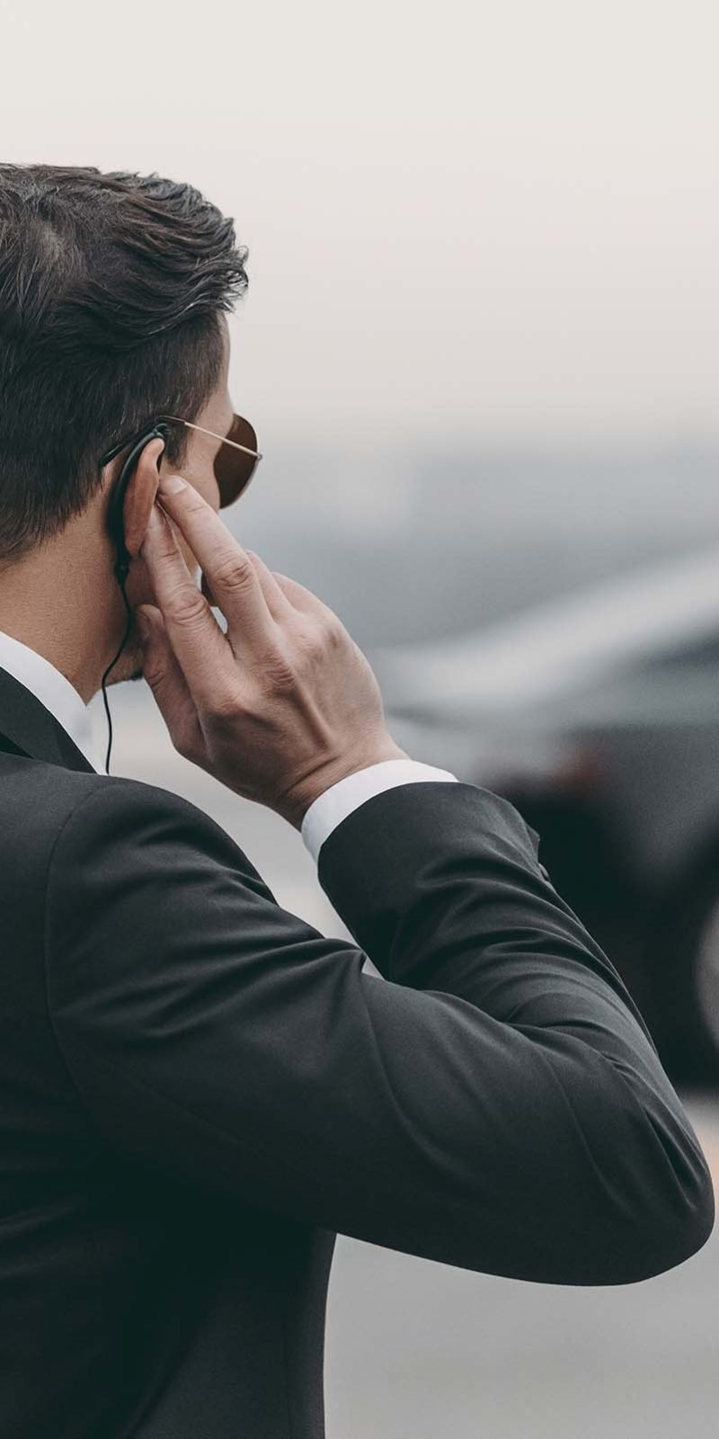 handsome-bodyguard-standing-and-listening-message-A78BNHN.jpg
